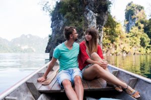 traveling-couple-love-hugging-relaxing-longtail-boat-thai-island-lagoon-pretty-woman-her-handsome-man-spending-vacation-time-together-happy-mood-adventure-time-min